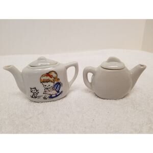 Mini tea pots one is painted both made in Japan two inches tall lot 113